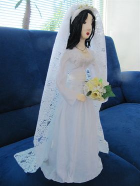 Dit bruidje is eigenlijk een originele manier om geld als huwelijkskado te geven. Onder haar rok zit een fles en een envelop waar je geld in kan doen.